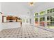 Open concept living room and kitchen with tiled floors, fireplace, bright windows, and access to the deck at 13832 Queenswater Ln, Charlotte, NC 28273