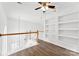 Spacious loft area featuring hardwood floors, built-in shelving, and natural light at 13832 Queenswater Ln, Charlotte, NC 28273