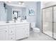 Well-lit bathroom featuring a double vanity, white cabinetry, and a glass-enclosed shower with a bench at 147 Commerce Blvd # 0003, Lancaster, SC 29720