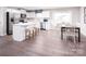 Bright kitchen with stainless steel appliances, island with bar stool seating, and an adjacent dining area at 147 Commerce Blvd # 0003, Lancaster, SC 29720