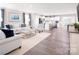 Spacious open-concept living area with hardwood floors flowing into a kitchen with an island and stainless appliances at 147 Commerce Blvd # 0003, Lancaster, SC 29720