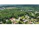 Overhead shot showcasing a neighborhood with tree-lined streets and community pool at 1616 Indian Springs Nw Dr, Conover, NC 28613