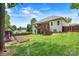 Beautiful fenced backyard with lush grass, a playset, covered deck, and wooded views at 1616 Indian Springs Nw Dr, Conover, NC 28613