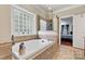 Bathroom featuring a large tub, and a glass block window at 1616 Indian Springs Nw Dr, Conover, NC 28613