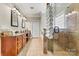 Elegant bathroom with double vanity, tub, and glass-enclosed shower with neutral tile at 1616 Indian Springs Nw Dr, Conover, NC 28613