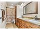 Bathroom showcasing a double sink vanity, granite countertops, and decorative mirror at 1616 Indian Springs Nw Dr, Conover, NC 28613