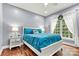Bedroom features a large bed with wood floors and a sunny window with decorative wreath at 1616 Indian Springs Nw Dr, Conover, NC 28613