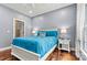 Well-lit bedroom with plush bedding, hardwood floors, and views from a sunny window at 1616 Indian Springs Nw Dr, Conover, NC 28613