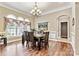 Formal dining room with hardwood floors, elegant chandelier, and large windows at 1616 Indian Springs Nw Dr, Conover, NC 28613
