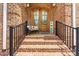 Charming brick home featuring a welcoming front porch, decorative door, and beautiful landscaping at 1616 Indian Springs Nw Dr, Conover, NC 28613