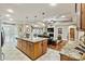 Open kitchen featuring an island with granite countertops and stainless steel sink overlooking the living room with a fireplace at 1616 Indian Springs Nw Dr, Conover, NC 28613