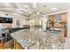 Granite island countertop featuring a sink, seating, and pendant lighting in an open concept kitchen space at 1616 Indian Springs Nw Dr, Conover, NC 28613
