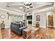 Cozy living room featuring a fireplace, tray ceilings, hardwood flooring, and ample natural light at 1616 Indian Springs Nw Dr, Conover, NC 28613