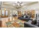 Open-concept living room with hardwood floors, ceiling fan, and seamless flow to the kitchen and dining area at 1616 Indian Springs Nw Dr, Conover, NC 28613