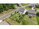 An aerial view showing a well-maintained backyard with trampoline, bordered by black metal fence, and surrounding neighborhood at 17637 Snug Harbor Rd, Charlotte, NC 28278