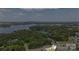 An aerial view of a wooded area with a lake in the background and a residential area in the foreground at 17637 Snug Harbor Rd, Charlotte, NC 28278