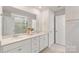Bright bathroom featuring double sinks with white vanities, a large mirror, and a glass-enclosed shower at 17637 Snug Harbor Rd, Charlotte, NC 28278