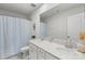 Bathroom with dual sinks, light blue shower curtain, white cabinets, and a large mirror at 17637 Snug Harbor Rd, Charlotte, NC 28278