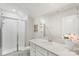 Bright bathroom with a glass shower, vanity, white cabinets, and a modern design at 17637 Snug Harbor Rd, Charlotte, NC 28278
