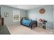 Cozy bedroom with a bed, side table, bookshelf with toys, and a window bringing in natural light at 17637 Snug Harbor Rd, Charlotte, NC 28278