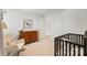 Well-lit Bedroom featuring a rocker, dresser, crib, and simple decor, perfect for a calming environment at 17637 Snug Harbor Rd, Charlotte, NC 28278