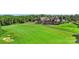 Aerial view of the clubhouse and golf course in a lush, green landscape at 17637 Snug Harbor Rd, Charlotte, NC 28278