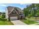 Charming two-story home with landscaped yard, paved driveway, and lush green trees at 17637 Snug Harbor Rd, Charlotte, NC 28278