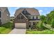 Beautiful two-story home featuring a brick facade, attached garage, and well-manicured lawn at 17637 Snug Harbor Rd, Charlotte, NC 28278