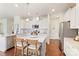 Bright, open kitchen with stainless steel appliances, white cabinetry and a large center island with seating at 17637 Snug Harbor Rd, Charlotte, NC 28278