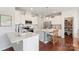 Beautiful kitchen with stainless steel appliances, white cabinetry and a large center island with seating and butler's pantry at 17637 Snug Harbor Rd, Charlotte, NC 28278