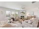 Bright living room with a fireplace, ceiling fan, hardwood floors, and large windows at 17637 Snug Harbor Rd, Charlotte, NC 28278