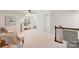 Bright and airy living room space with neutral carpet, ceiling fan, and a window bringing in natural light at 17637 Snug Harbor Rd, Charlotte, NC 28278