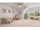 Bright and airy living room space with neutral carpet, ceiling fan, and a large window bringing in natural light at 17637 Snug Harbor Rd, Charlotte, NC 28278