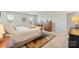 Spacious main bedroom with neutral carpet, a large bed with bedside tables and a decorative area rug at 17637 Snug Harbor Rd, Charlotte, NC 28278