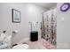 Functional bathroom with a shower featuring stylish curtain and flooring at 1836 Fairlawn Ct, Rock Hill, SC 29732