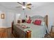 Comfortable bedroom with a large bed, ceiling fan, wood laminate flooring, and ensuite bathroom access at 1836 Fairlawn Ct, Rock Hill, SC 29732