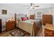 Cozy bedroom with a large bed, ceiling fan, wood laminate flooring, and natural light from the window at 1836 Fairlawn Ct, Rock Hill, SC 29732