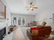 Cozy living room features a fireplace, ceiling fan, and access to outdoor patio through sliding glass doors at 1836 Fairlawn Ct, Rock Hill, SC 29732