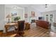 Living room/office combo featuring neutral walls, a fireplace, and natural light, blending work and living spaces at 1836 Fairlawn Ct, Rock Hill, SC 29732
