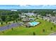 Scenic aerial view showcasing community amenities: pool, tennis courts, clubhouse, parking and lake views at 18619 Mainsail Ct, Lancaster, SC 29720