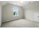 Bright bedroom with a window view and neutral carpet at 18619 Mainsail Ct, Lancaster, SC 29720