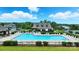 A beautiful community pool with lounge chairs, clubhouse, and well-maintained landscaping on a bright, sunny day at 18619 Mainsail Ct, Lancaster, SC 29720