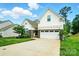 Beautiful home with a well-manicured lawn, two-car garage, and charming architectural details at 18619 Mainsail Ct, Lancaster, SC 29720