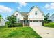 Charming two-story home with stone accents, a well-manicured lawn, and an attached two-car garage at 18619 Mainsail Ct, Lancaster, SC 29720