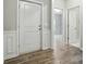 Clean foyer with light wood flooring, white wainscoting, and a glimpse into a room at 18619 Mainsail Ct, Lancaster, SC 29720