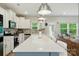 Well-lit kitchen features an island with bar stools, stainless steel appliances, and modern cabinetry at 18619 Mainsail Ct, Lancaster, SC 29720