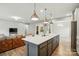 Open kitchen and living area features an island with seating and stainless steel appliances at 18619 Mainsail Ct, Lancaster, SC 29720