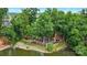 An aerial perspective of a lakefront area with scenic landscaping and a tiered pathway leading to the water's edge at 18619 Mainsail Ct, Lancaster, SC 29720