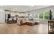 Open-concept living room boasts hardwood floors, natural light, and flows into modern kitchen at 18619 Mainsail Ct, Lancaster, SC 29720