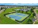 Aerial shot featuring community tennis courts, a pool, and clubhouse amidst grassy lawns and surrounding residential homes at 18619 Mainsail Ct, Lancaster, SC 29720